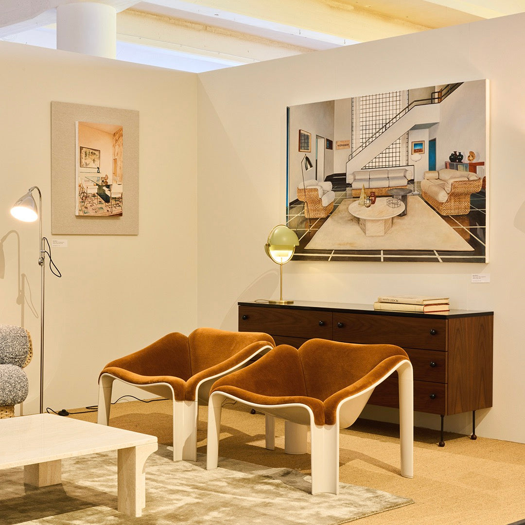 "Stylish orange and white chairs against a neutral backdrop with geometric patterns in a modern living space."