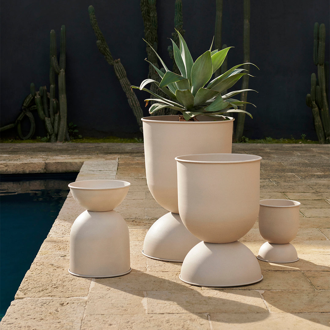 Neutral-colored modern planters with smooth, rounded shapes and minimalistic design, perfect for indoor or outdoor use.