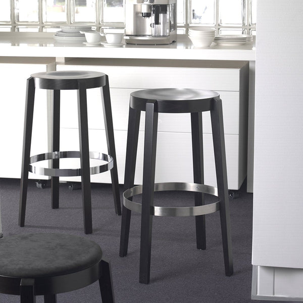 Black bar stools with sleek silver rings, featuring a minimalist design, set against a neutral kitchen backdrop.