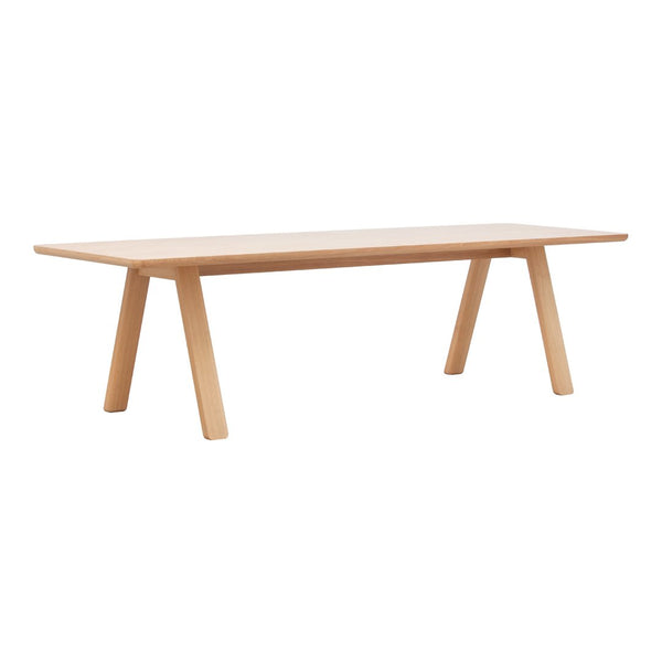 Light natural wood dining table with a smooth surface and minimalist design, featuring tapered legs.