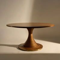 Round wooden table with a spiral base, showcasing a rich, warm brown finish and smooth, polished surface.