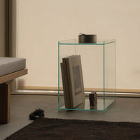 Clear glass side table featuring minimalistic design with sleek edges and a modern aesthetic.