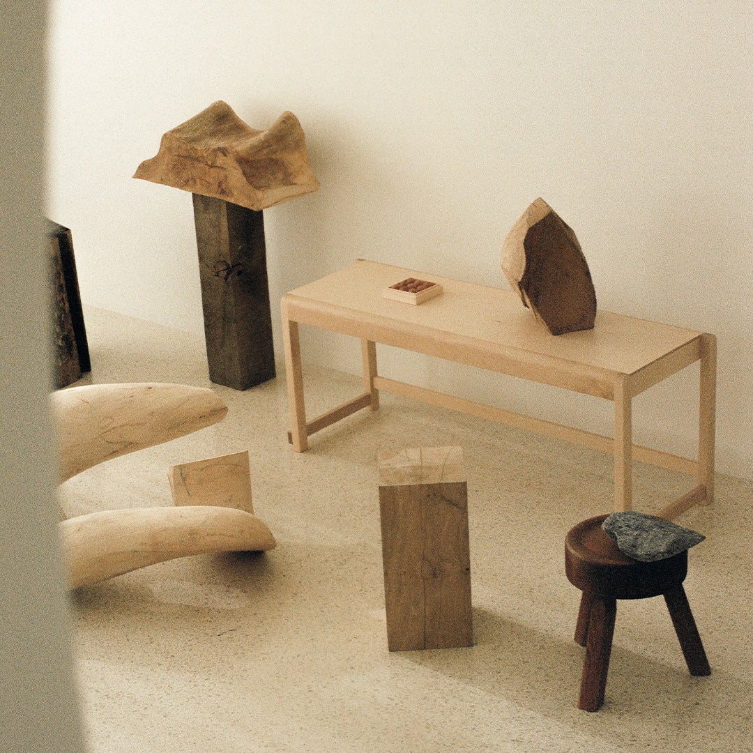 Natural wood tones, smooth textures, and unique patterns create an inviting, modern decor environment.