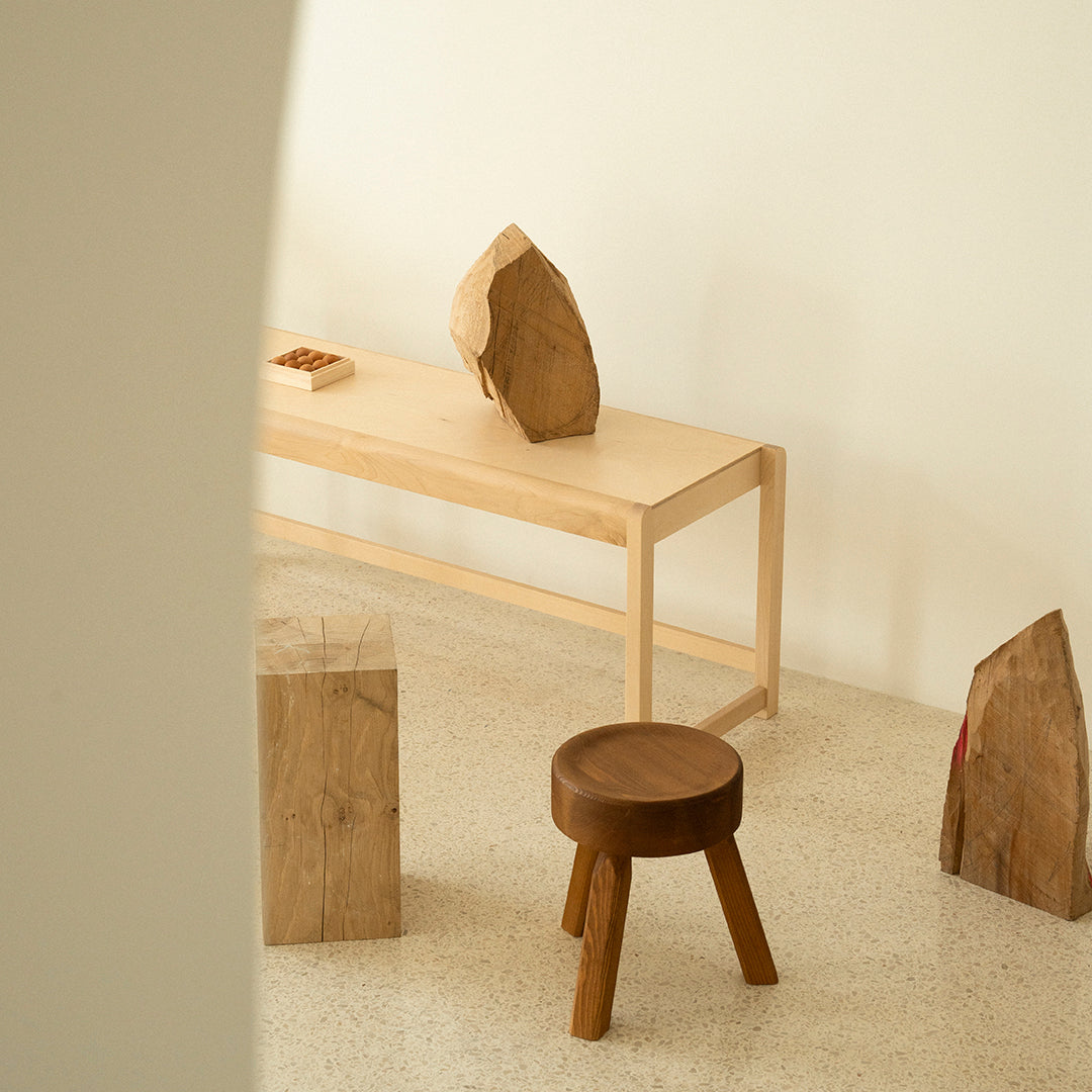 Natural wood tones with minimalist design; smooth finishes and earthy textures create a warm, inviting ambiance.