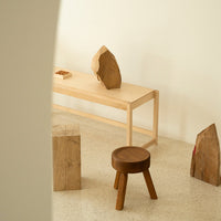 Natural wood tones with minimalist design; smooth finishes and earthy textures create a warm, inviting ambiance.