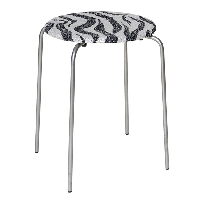 Black and white zigzag patterned stool with sleek metal legs. Modern design for versatile decor.