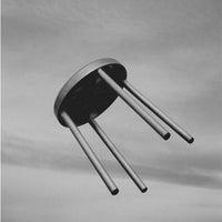"Minimalist black and white stool with four sleek metallic legs and a round base, featuring smooth, contemporary lines."