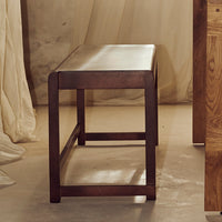 "Solid dark wood bench with a sleek, modern design and smooth finish, perfect for adding warmth to any space."