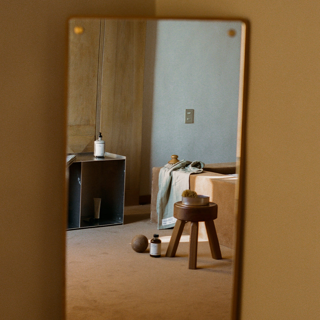 Neutral beige walls with earthy tones, natural wood textures, and a minimalist design reflect a cozy, modern vibe.