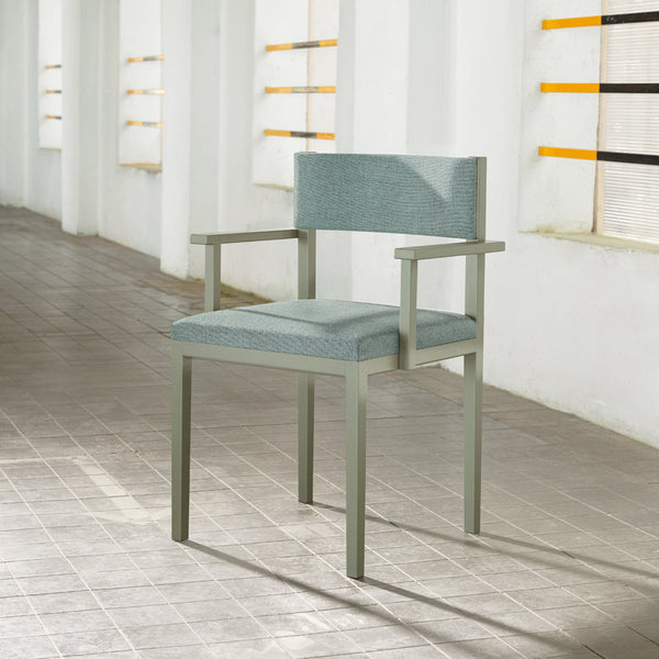 Light blue upholstered chair with a textured pattern, complemented by a sleek metal frame. Modern and stylish design.
