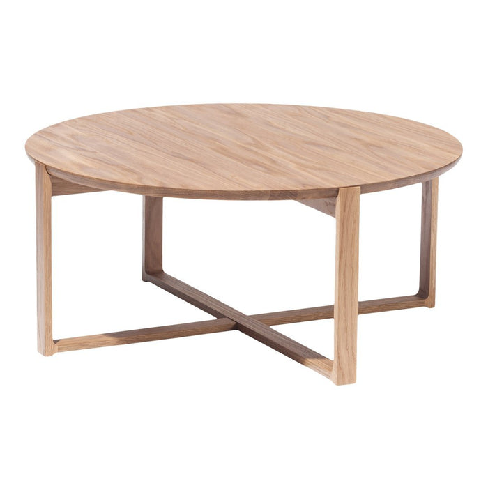 Round wooden coffee table with a natural oak finish and minimalist design featuring a smooth tabletop and tapered legs.