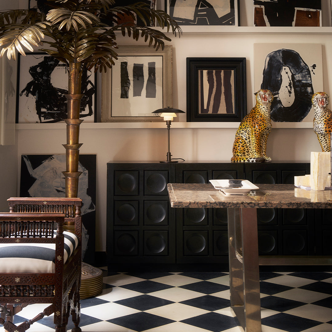 Stylish black and white checkered floor with vibrant gold and leopard-patterned décor, enhancing modern interior design.