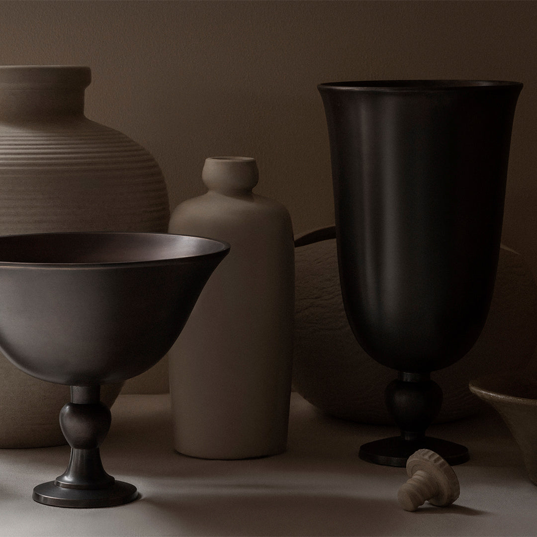 "Elegant dark and light pottery with smooth and textured finishes, showcasing a minimalist color palette."