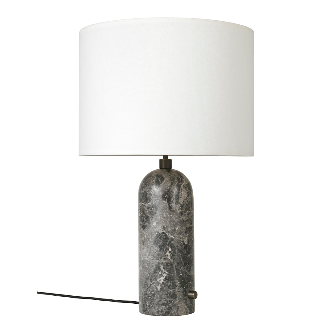 Gray marble lamp base with a sleek white cylindrical shade and minimalist design. Perfect for modern decor.