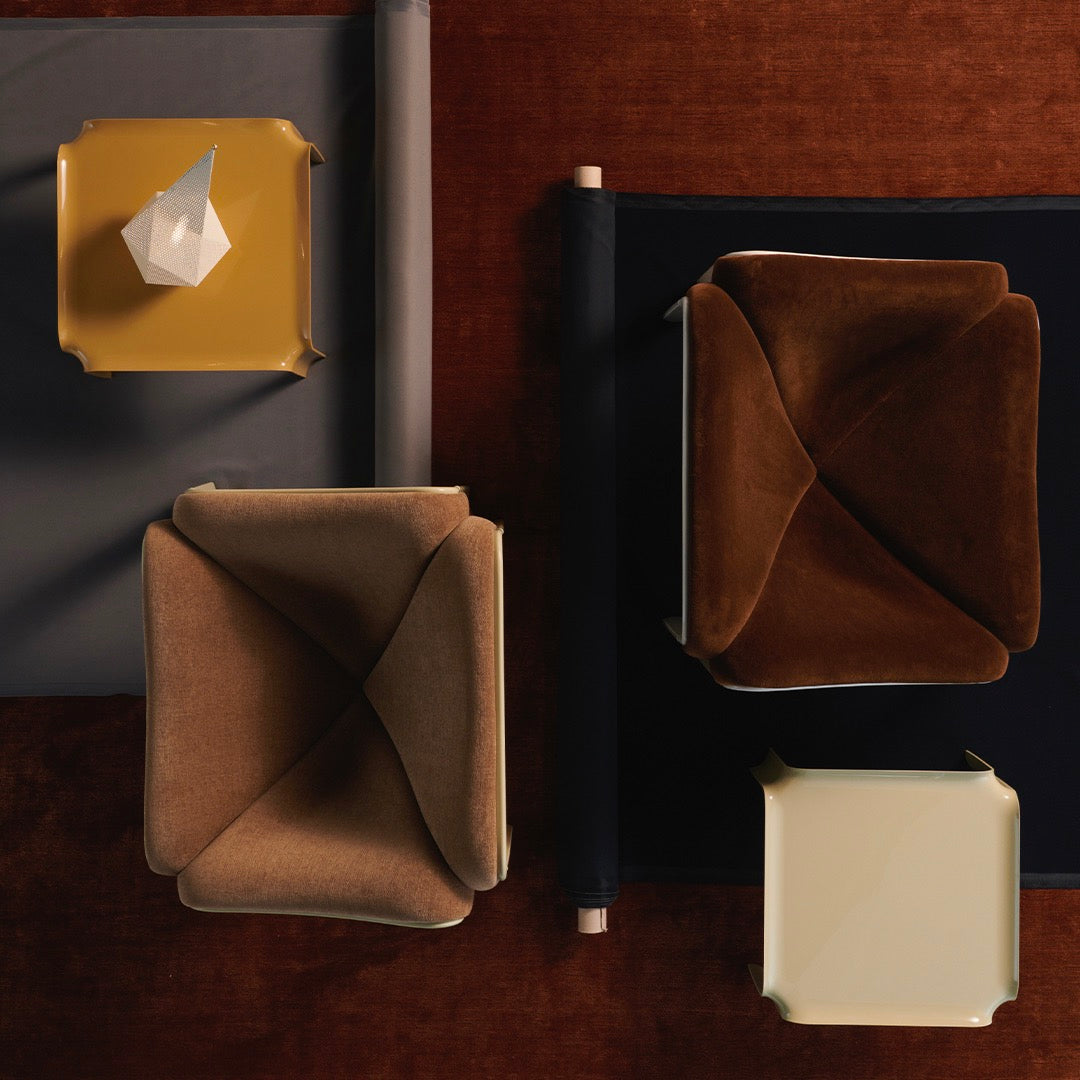 Modern seating in warm brown and tan hues with geometric patterns on a textured rust background.