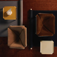 Modern seating in warm brown and tan hues with geometric patterns on a textured rust background.