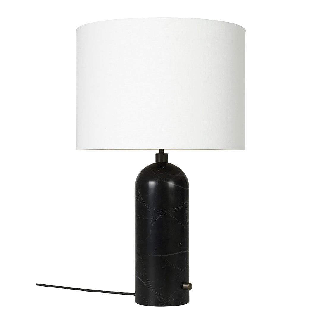 Black marble lamp base with a white drum shade, adding sleek elegance to any decor.