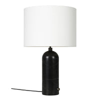 Black marble lamp base with a white drum shade, adding sleek elegance to any decor.