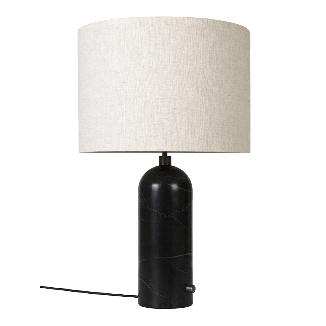 Black marble lamp base with a cream linen shade, featuring a smooth, modern design. Perfect for stylish decor.