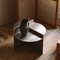 Round metal side table with a matte gray finish, featuring a sleek, modern design and soft, curved edges.