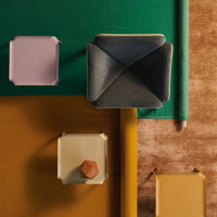 Colorful geometric patterns with green, yellow, pink, and gray furniture pieces arranged on a textured brown background.