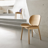 Modern wooden chair with a natural finish; minimalist design featuring smooth lines and subtle color accents.