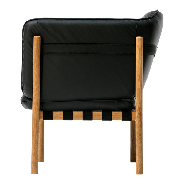 Black leather armchair with a wood frame and striped wooden base in natural tones. Elegant and modern design.