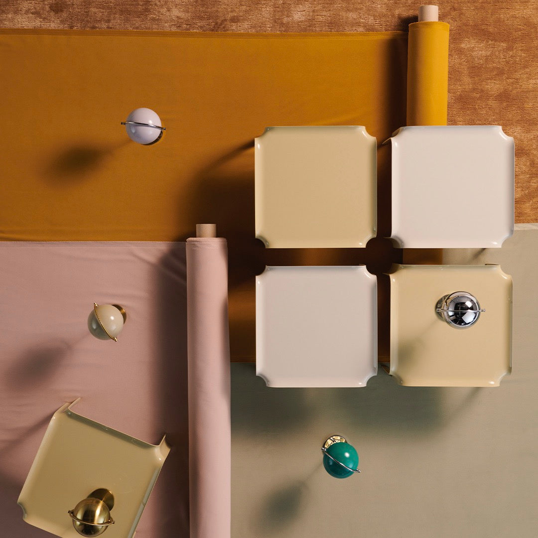 Colorful flat lay featuring mustard, soft pink, beige, and mint patterns with decorative spheres and square boxes.