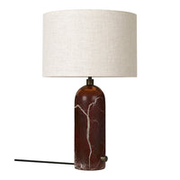 Brown marble lamp base with white veining, topped with a cream-colored linen shade. Modern and stylish design.
