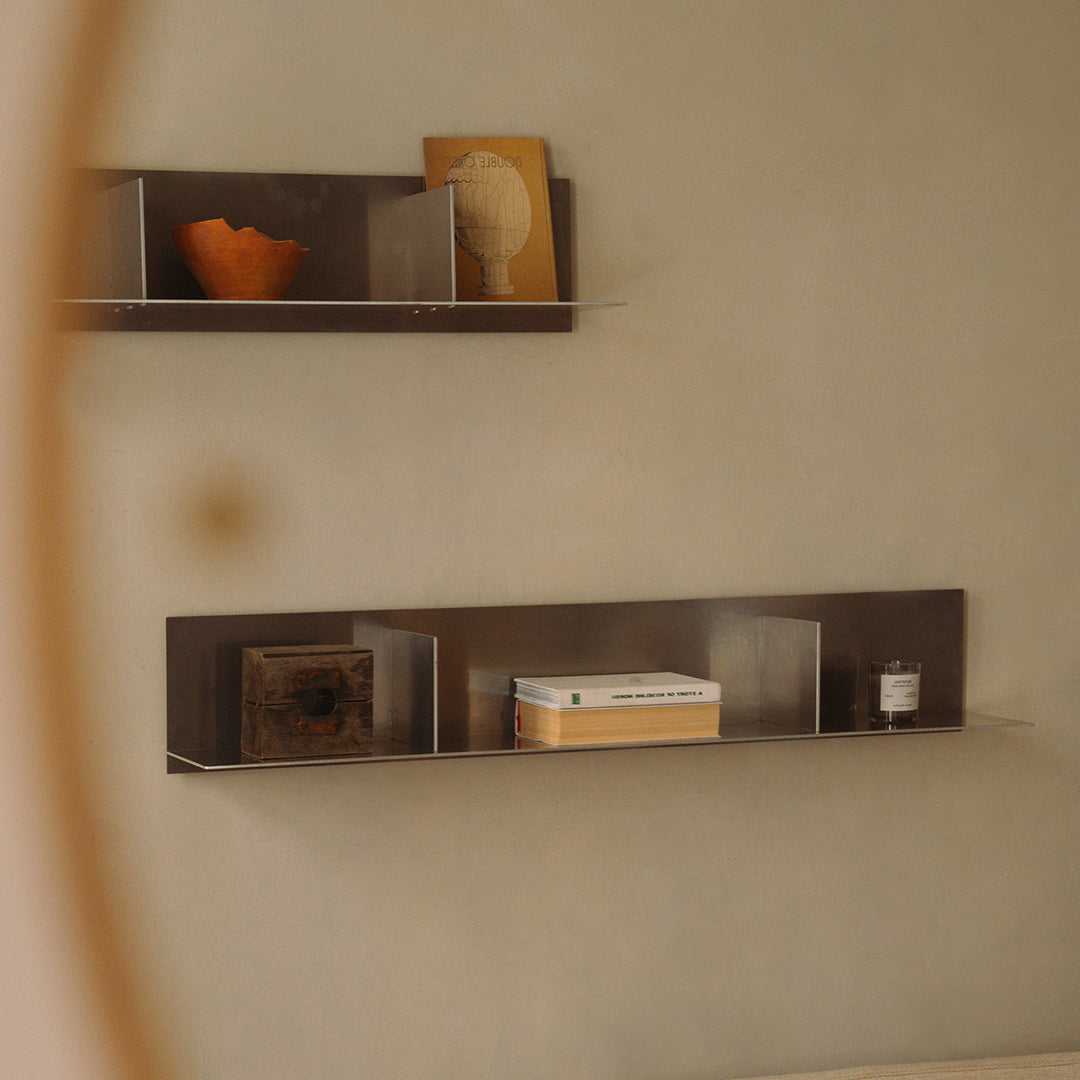 Minimalist shelving in earthy tones, featuring a geometric gray pattern, with warm orange and neutral decor accents.