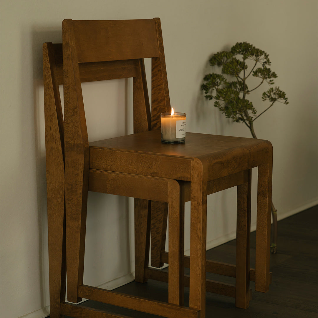 "Stacked wooden chair in warm brown tones, featuring a smooth finish and minimalist design."