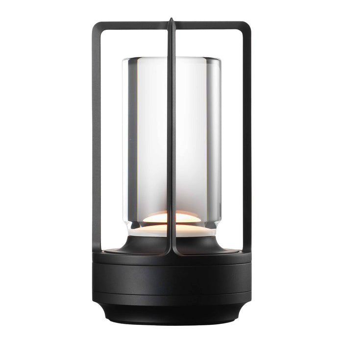 Black metal lantern with a clear glass shade and warm white light for a modern minimalist look.