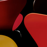 Colorful modern design featuring red, orange, yellow, and black shapes with smooth, glossy finishes.