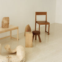Natural wood tones with smooth textures; minimalist design featuring a mix of light and dark finishes.