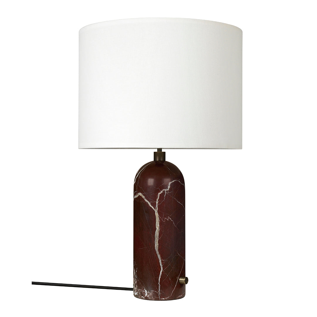 Elegant marble lamp in deep red with white veining and a sleek white drum shade, perfect for modern decor.