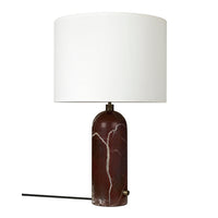 Elegant marble lamp in deep red with white veining and a sleek white drum shade, perfect for modern decor.