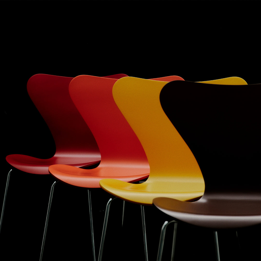Set of four modern chairs in gradient colors: red, orange, yellow, and brown, against a black background.