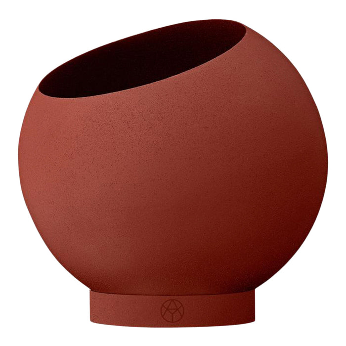 Round terracotta pot with a smooth, matte finish and a slightly tilted opening for a modern aesthetic.