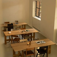 Wooden tables in a minimalist setting with natural wood tones and a soft, neutral color palette.