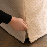 Beige textured fabric with a subtle woven pattern, featuring a stylish zipper detail at the seam.