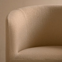 Beige textured fabric armchair with a soft, muted finish, perfect for a warm, modern decor.