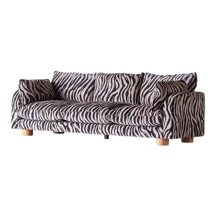 Zebra-patterned sofa in black and cream with wooden legs, featuring bold stripes for a striking home decor accent.