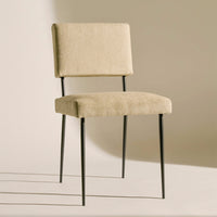 Beige upholstered chair with clean lines and black metal legs, perfect for modern decor.