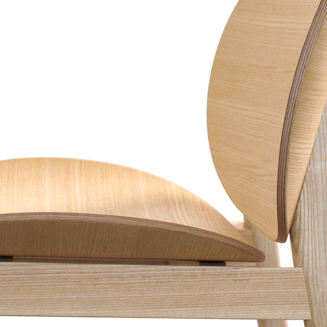 Light bamboo chair with smooth, natural wood grain and minimalist design, showcasing soft curves and subtle patterns.