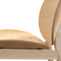 Light bamboo chair with smooth, natural wood grain and minimalist design, showcasing soft curves and subtle patterns.