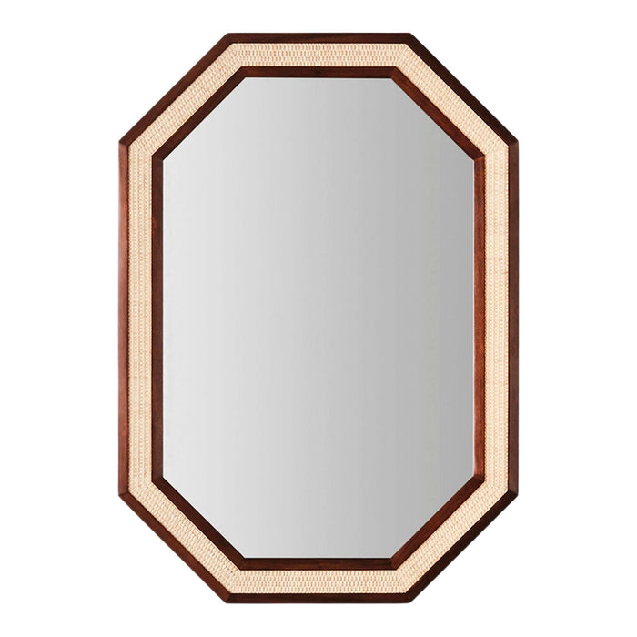 Wooden octagonal mirror with a dark brown frame and natural cane detailing, reflecting a stylish blend of colors and textures.
