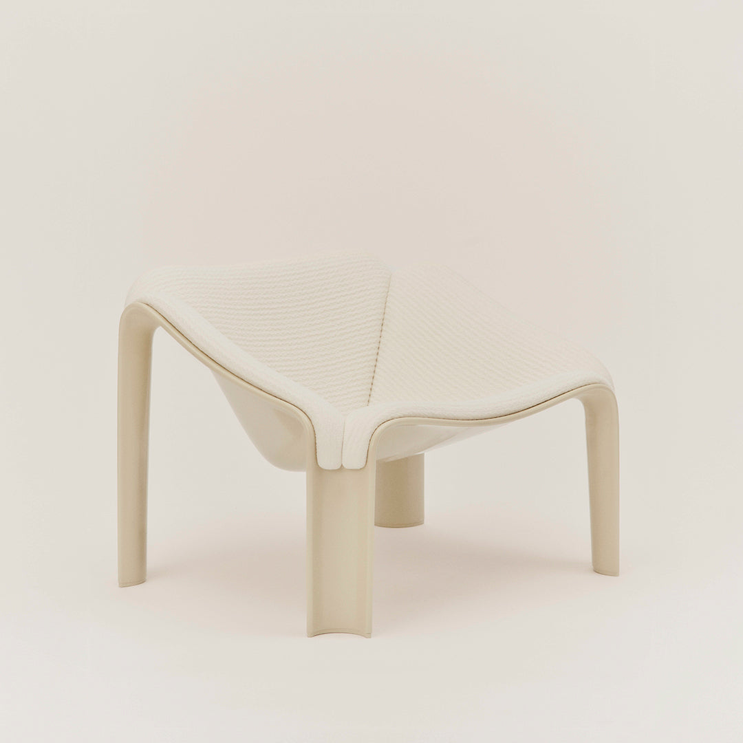 Beige modern chair with smooth curves and minimalistic design, featuring a clean, solid pattern.