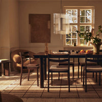 "Warm neutral tones with a textured beige rug and dark wood furniture, featuring subtle patterns and natural light."