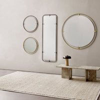 Four elegant mirrors with round and rectangular shapes, featuring gold accents, against a neutral wall and textured rug.
