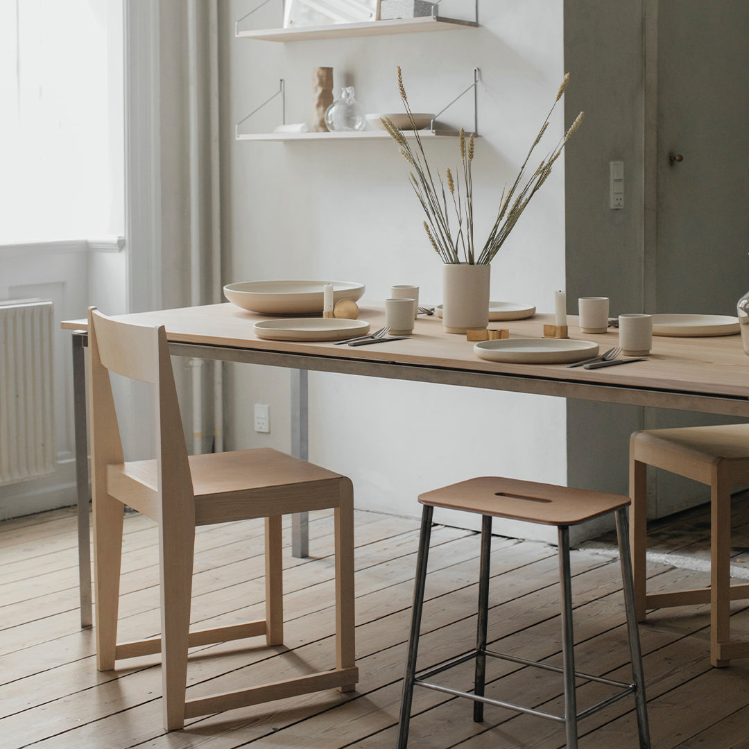 Light wood dining table with minimalist design, featuring neutral tones and subtle natural textures.